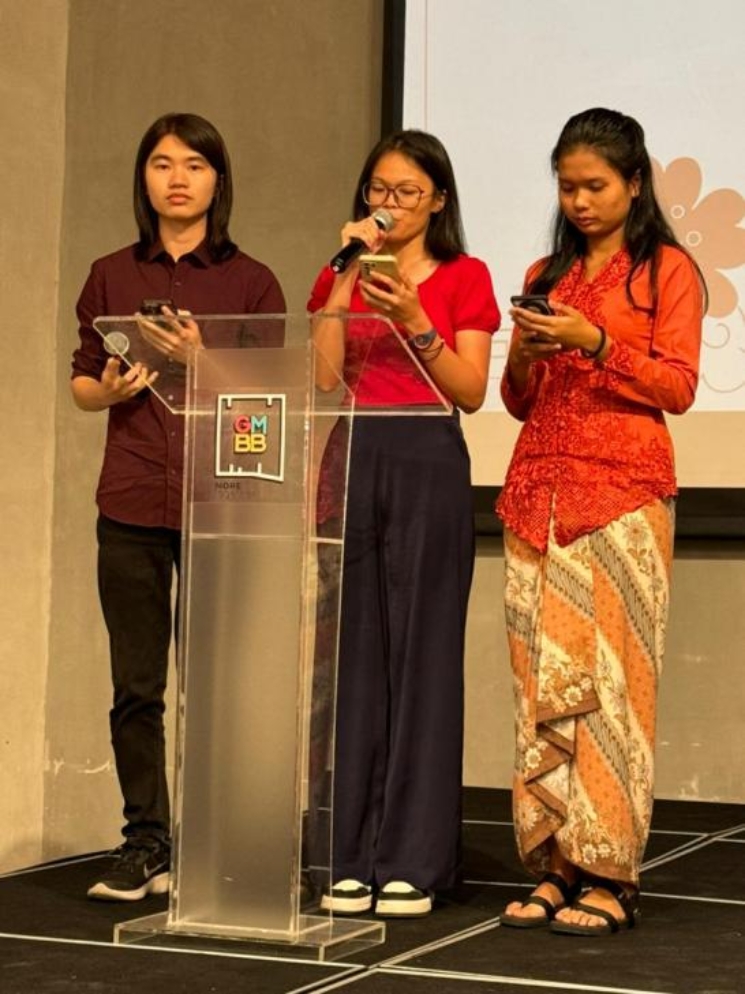 A group of people standing at a podiumDescription automatically generated